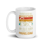 Never Underestimate and Old Man Who Loves Paragliding White glossy mug