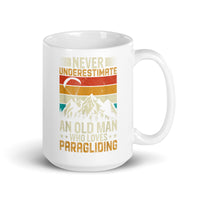 Never Underestimate and Old Man Who Loves Paragliding White glossy mug